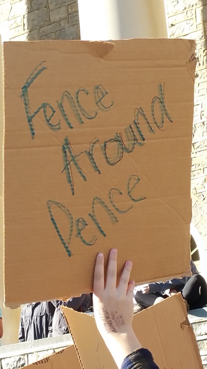 cardboard sign saying "Fence Around Pence" hand-printed with crayons.