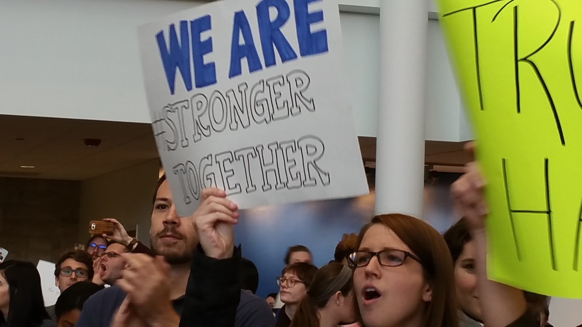 Hand-drawn sign that says, "We are stronger together."